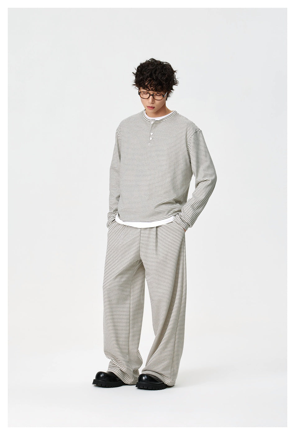 Model wearing an ivory thin-striped long-sleeve henley and matching wide-leg pants.