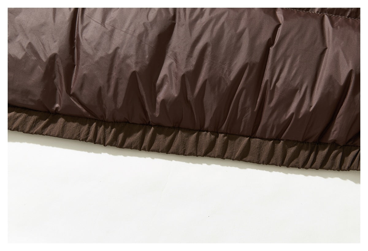 Close-up of the brown jacket's gathered elastic hem and padded outer panel.
