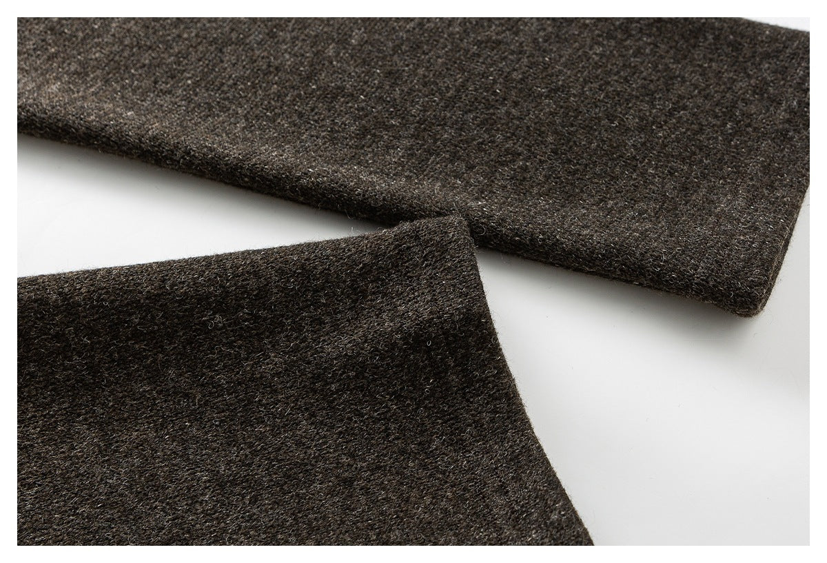 Close-up of overlapping sleeve or hem edges on a dark brown flecked coat.
