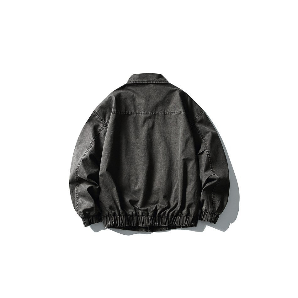Back view of black-gray washed jacket showing yoke seam, collar and elastic hem and cuffs