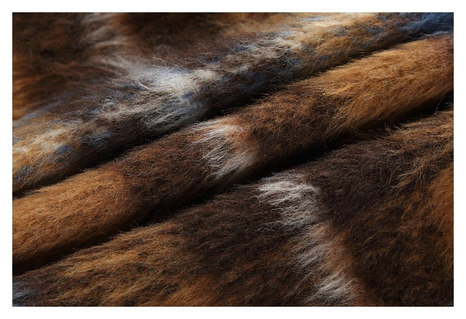 Close-up of fuzzy plaid fabric in brown, blue, gray, and cream tones.