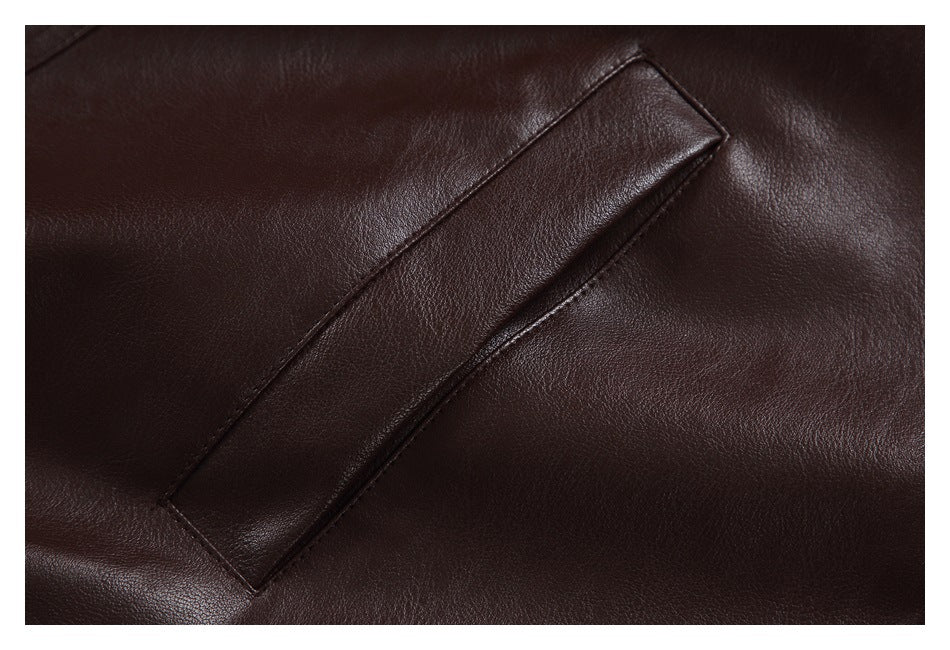 Close-up of a slanted welt pocket on the dark brown jacket.
