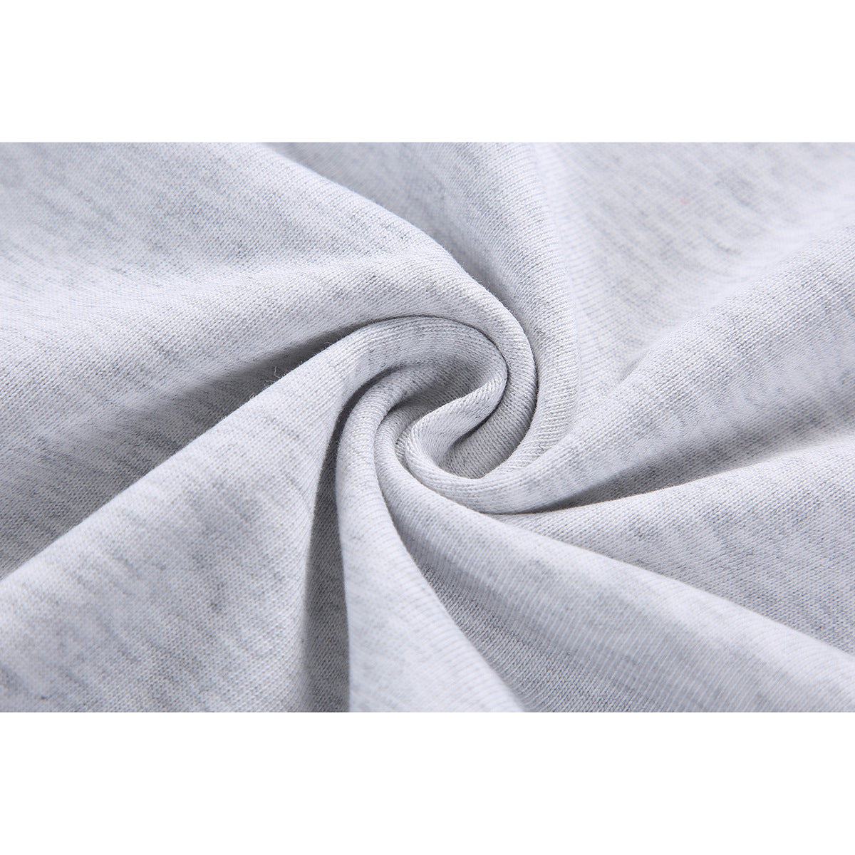 Close-up of light gray knit fabric gathered into folds, showing its surface texture.