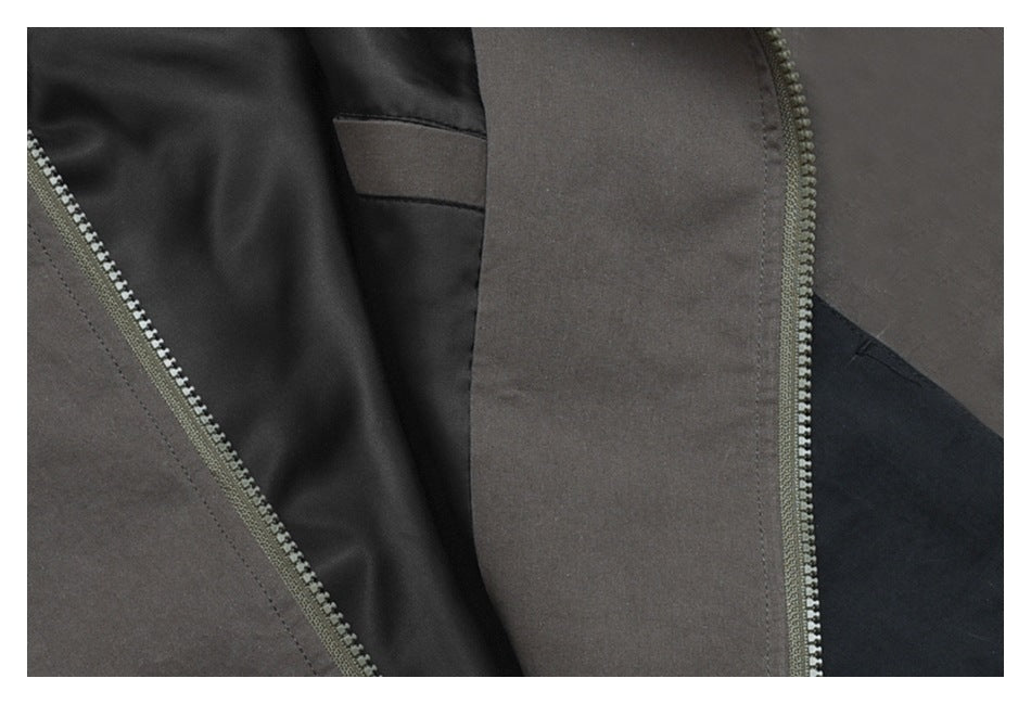 Close-up of the jacket's dark lining and two zippers along the charcoal and contrast fabric panels.
