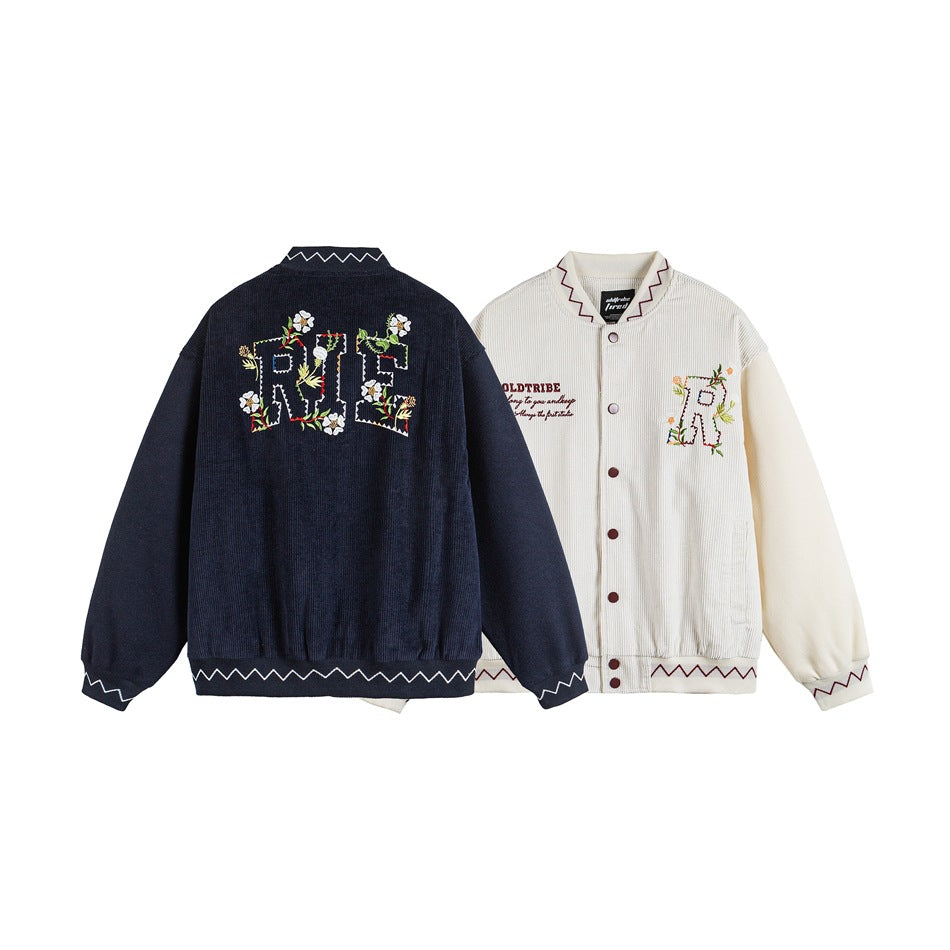Navy jacket back and cream jacket front, both with floral embroidered lettering and zigzag trim.