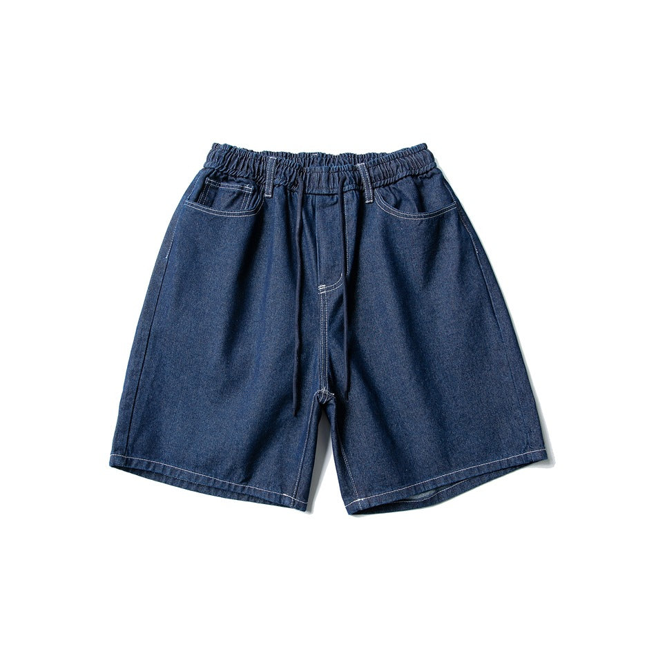 Dark blue denim shorts with elastic drawstring waist, front pockets and contrast stitching, flat lay front view