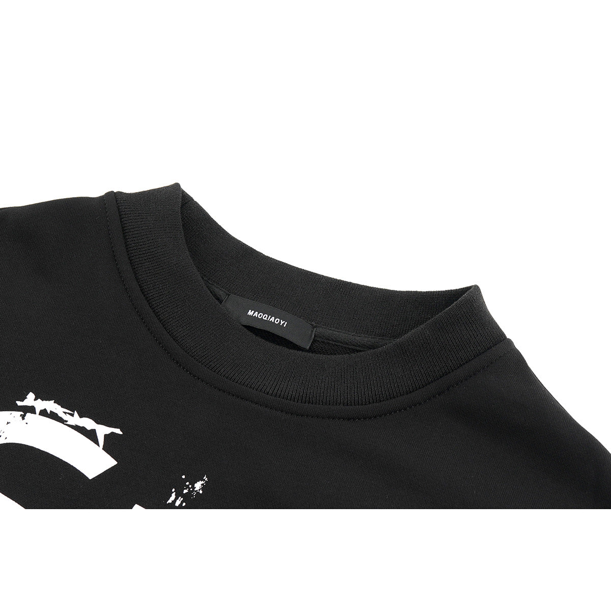 Close-up of a black crewneck shirt collar, neck label, and part of a white chest graphic.