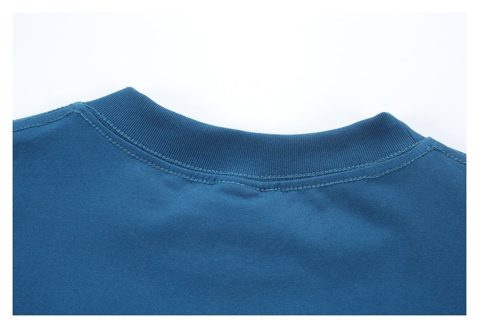 Close-up of the back neckline of a blue garment with a ribbed collar and visible stitching.