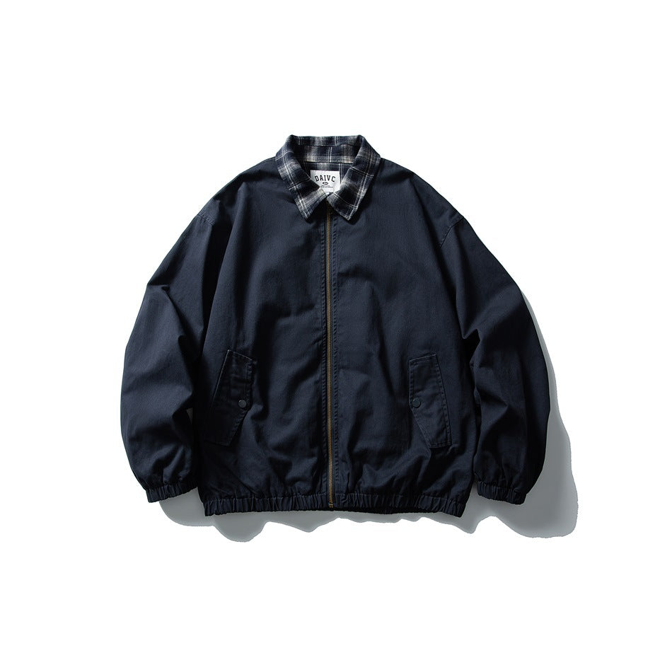 Navy zip-front jacket flat lay with plaid collar, flap pockets, and elastic cuffs and hem