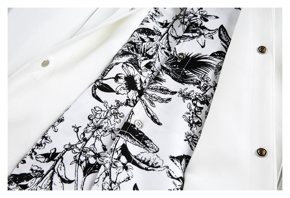 Opened white garment showing metal snaps and a black-and-white botanical printed inner panel.