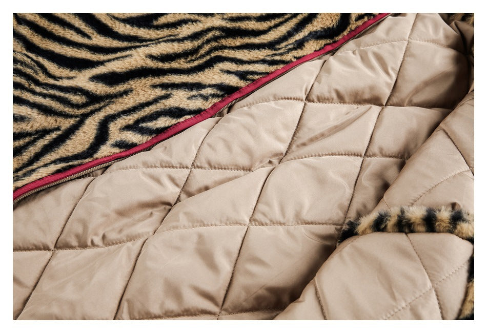 Close-up of beige diamond-quilted lining beside tiger-striped faux fur and burgundy trim.
