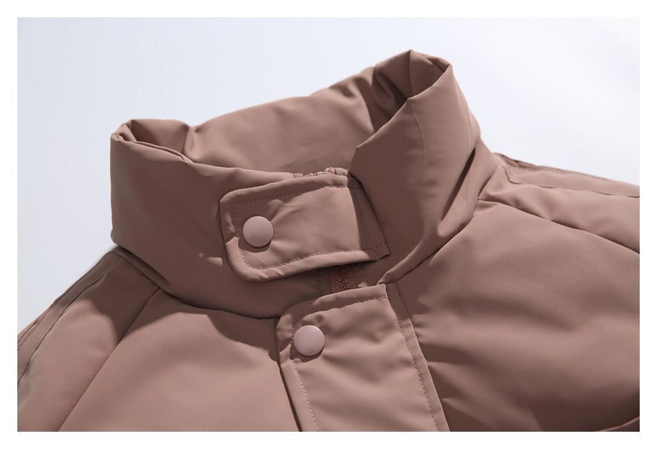Close-up of the dusty mauve jacket's high collar, snap tab and front snap closure.