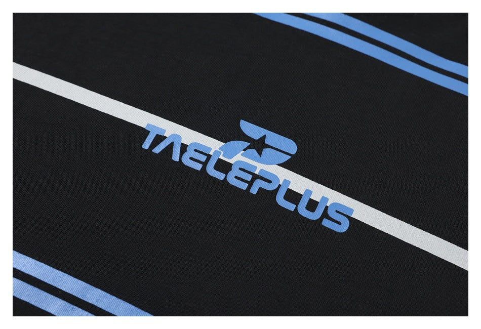 Close-up of black fabric with blue and white stripes and a blue-and-white TAELEPLUS graphic.