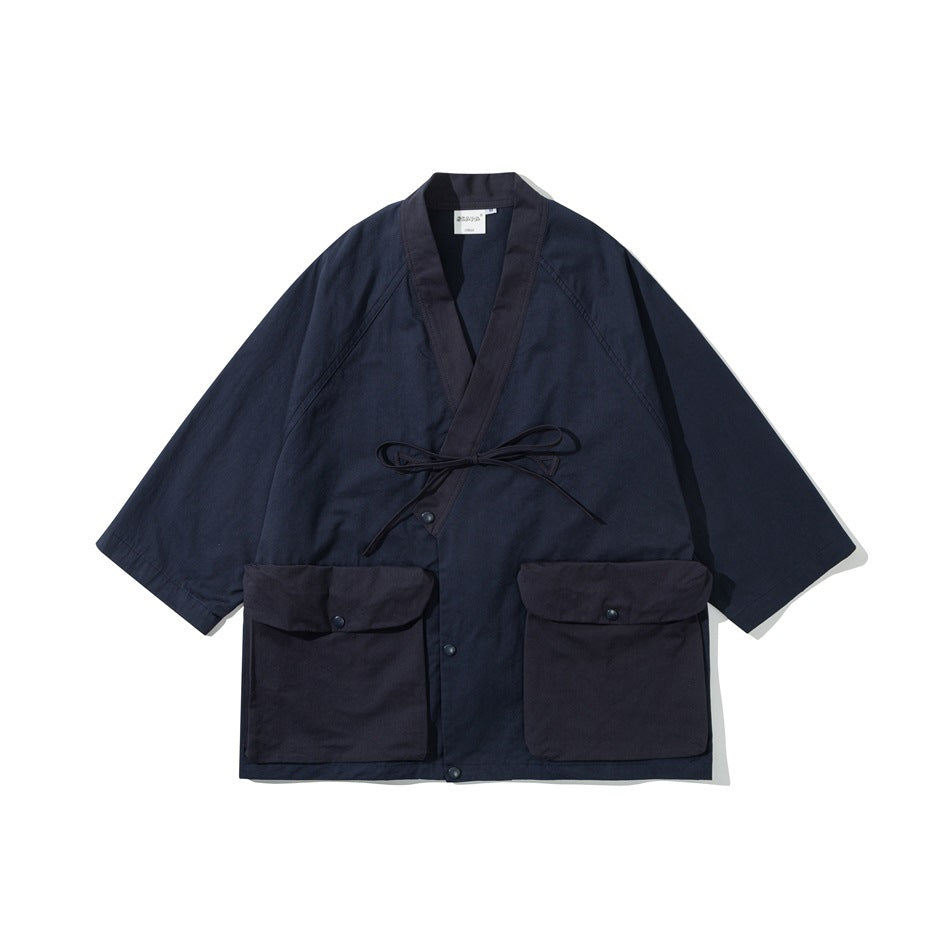 Navy kimono-style jacket with darker contrast collar, tie closure and two large flap pockets, flat front view