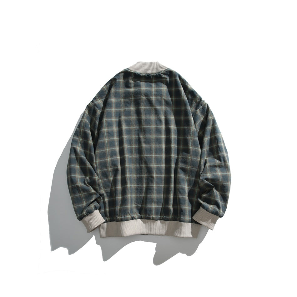 Back view of a dark green and navy plaid jacket with a cream ribbed collar, cuffs, and hem.
