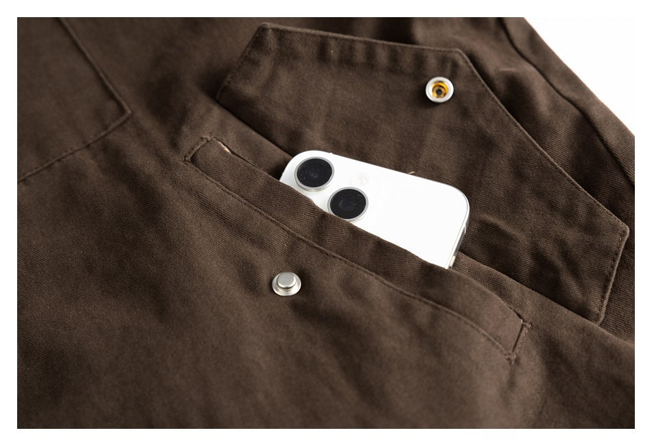 A white smartphone sits in a brown jacket pocket beneath a snap-button flap.