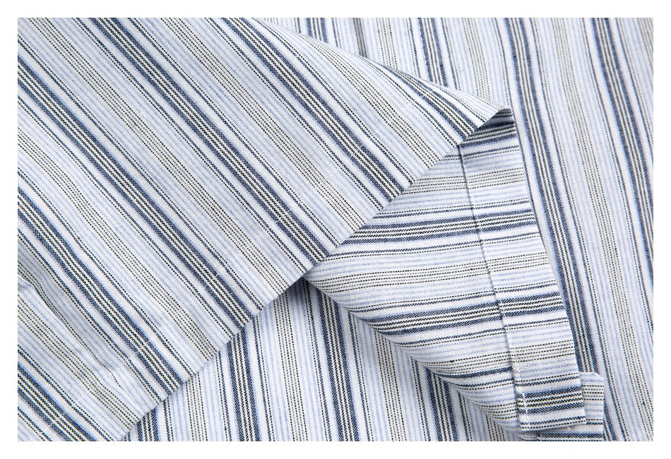 Close-up of a striped shirt sleeve and cuff, showing fine blue and gray lines and the cuff seam.