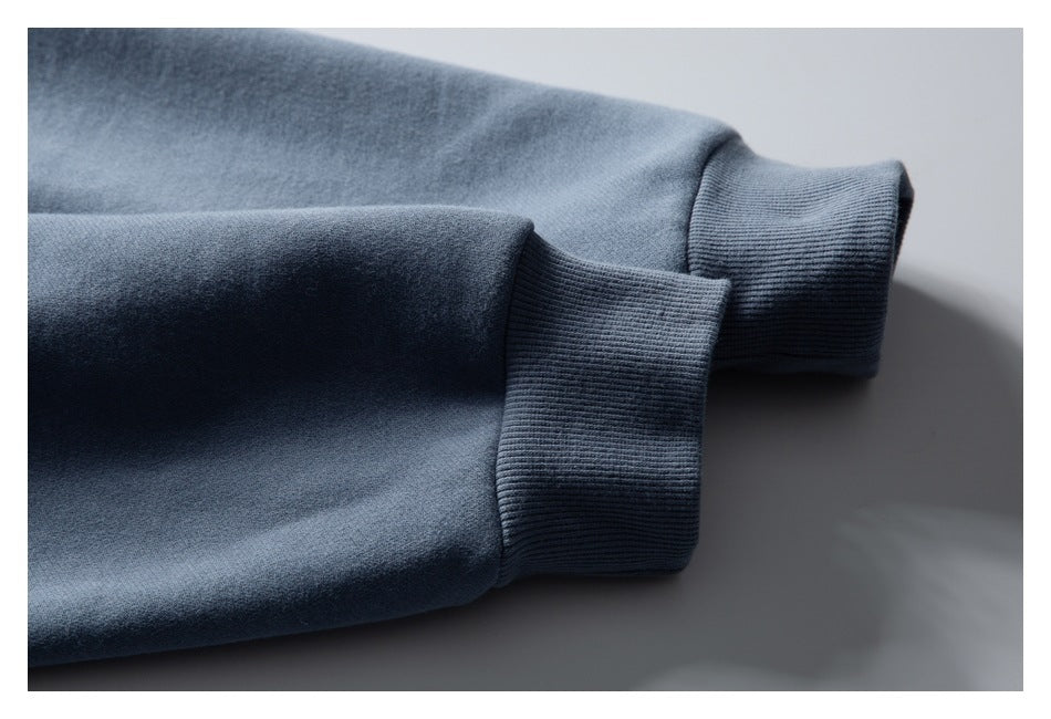 Close-up of a blue sleeve ending in a ribbed cuff.