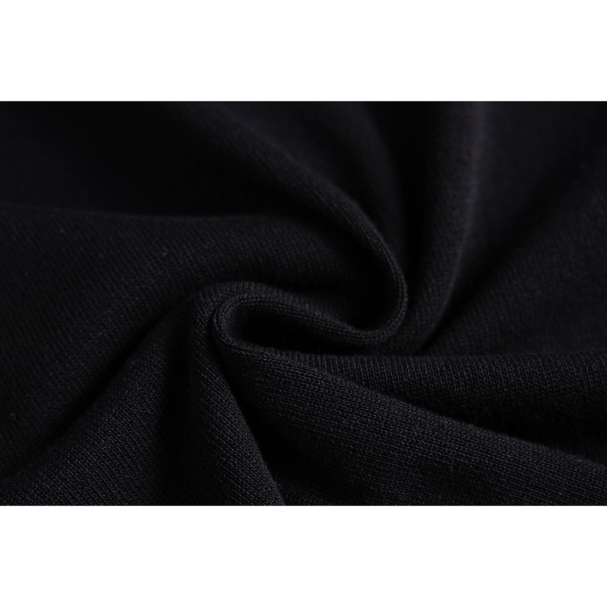 Close-up of the black knit fabric arranged in soft folds.
