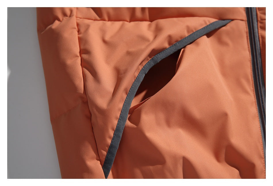Close-up showing a curved, black-edged pocket opening on the rust-orange jacket.