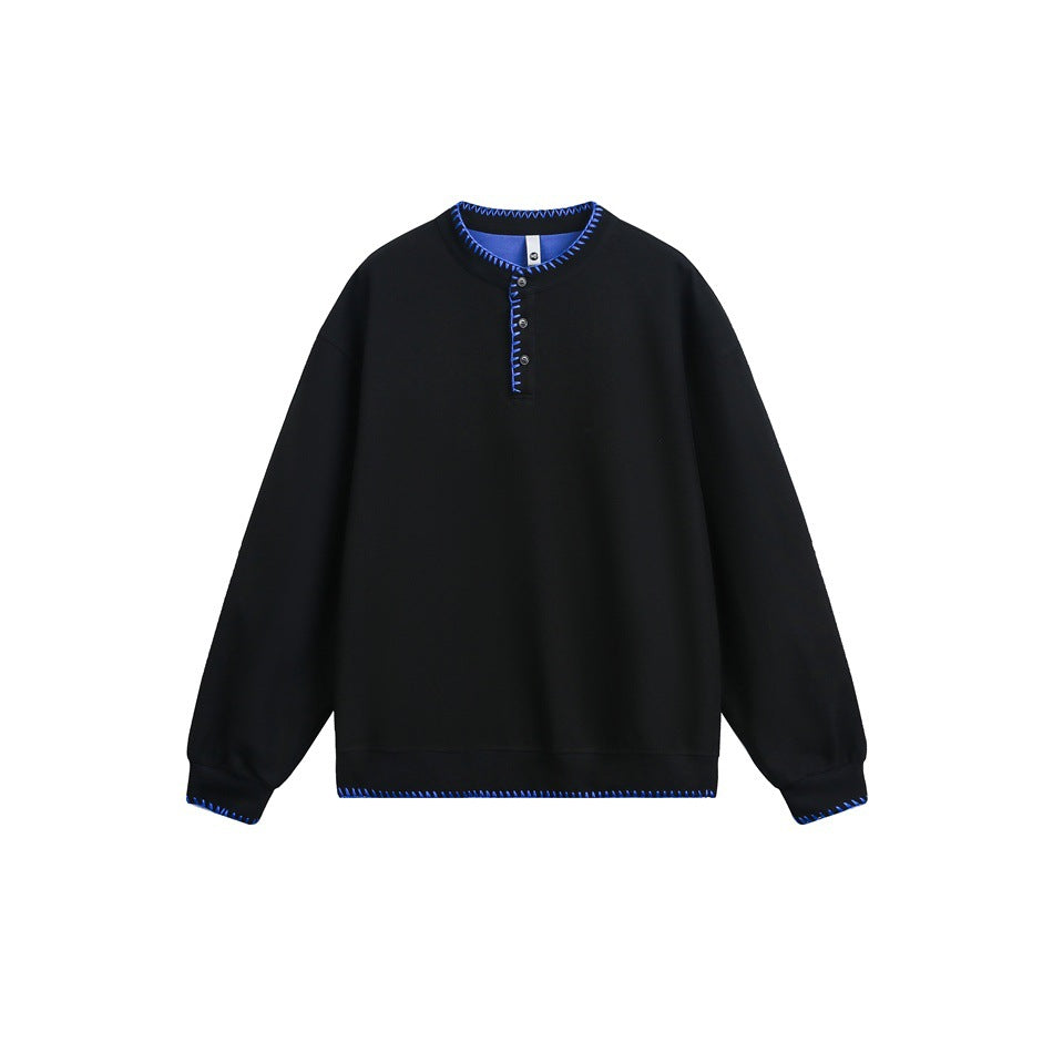 Black Henley sweatshirt with bright blue whipstitch trim on collar, placket, cuffs and hem, flat lay