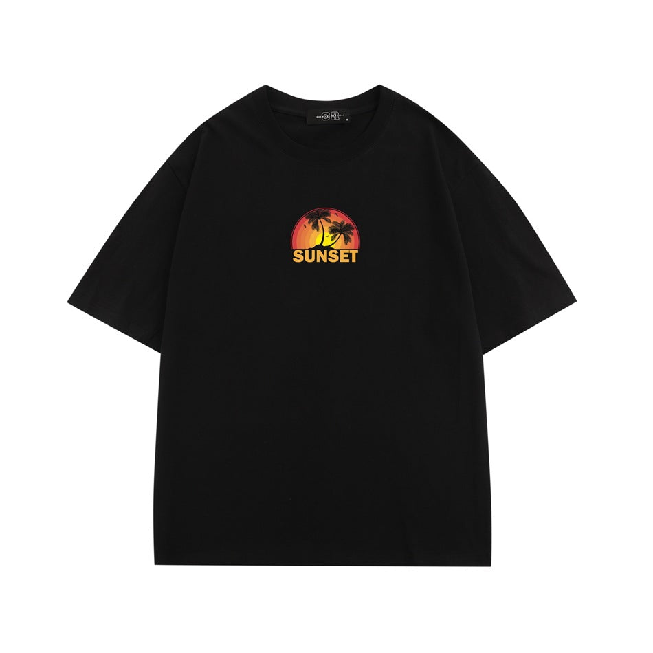 Black short-sleeve crew-neck T-shirt with a small orange sunset and palm tree graphic reading “SUNSET.”