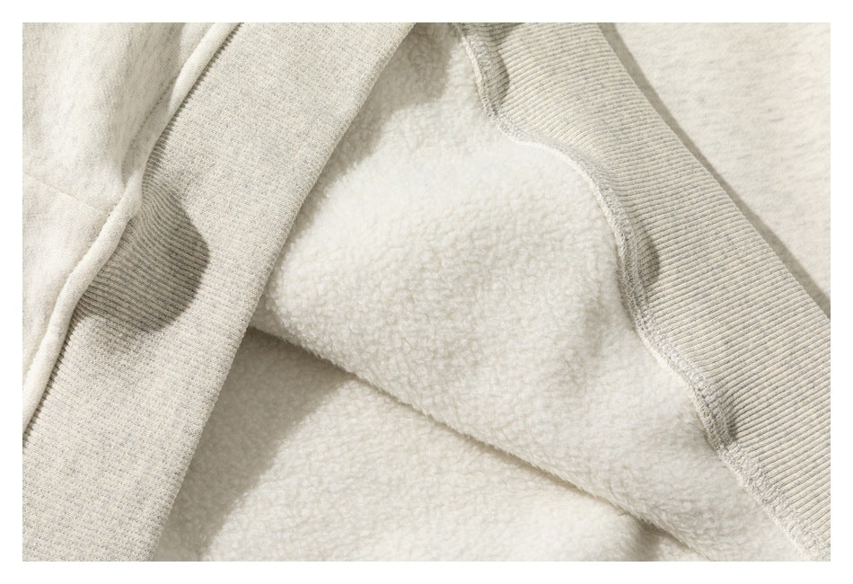 Close-up of cream fleece lining and light gray ribbed trim on a garment.