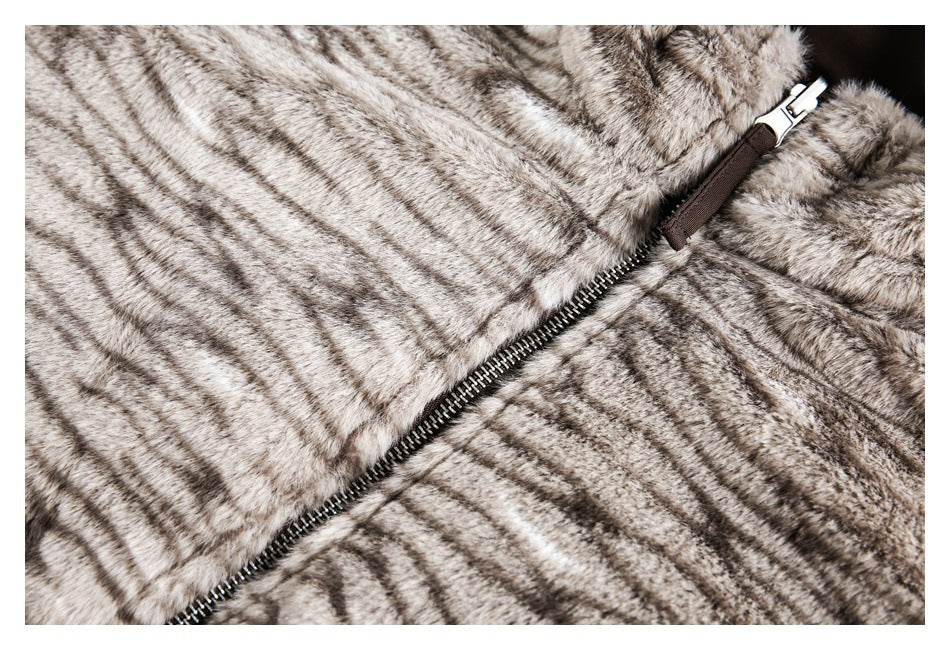 Close-up of a diagonal metal zipper on a gray-brown striped faux-fur garment.