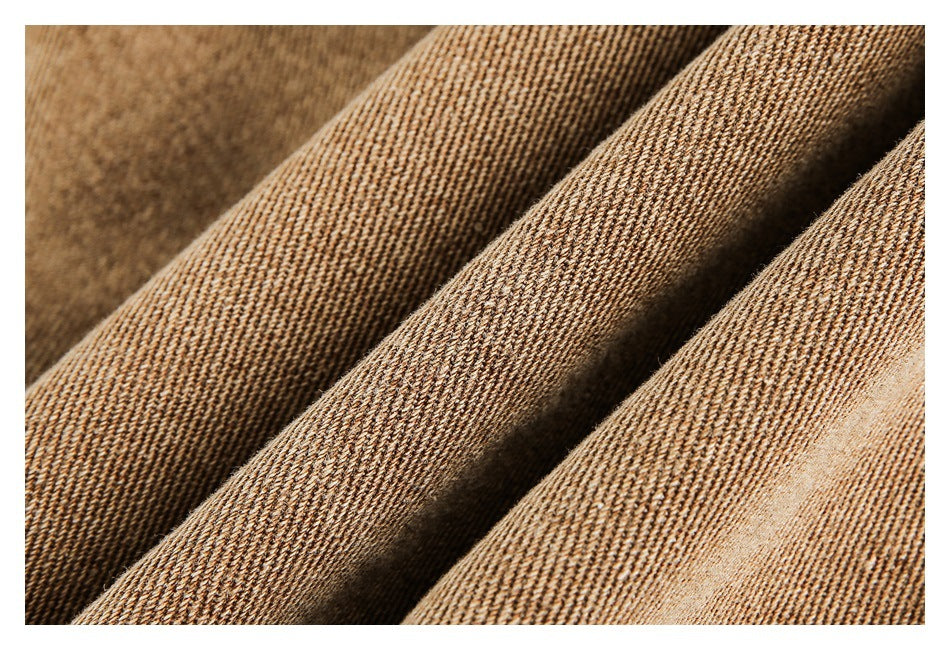Macro view of brown and tan woven fabric arranged in diagonal folds.