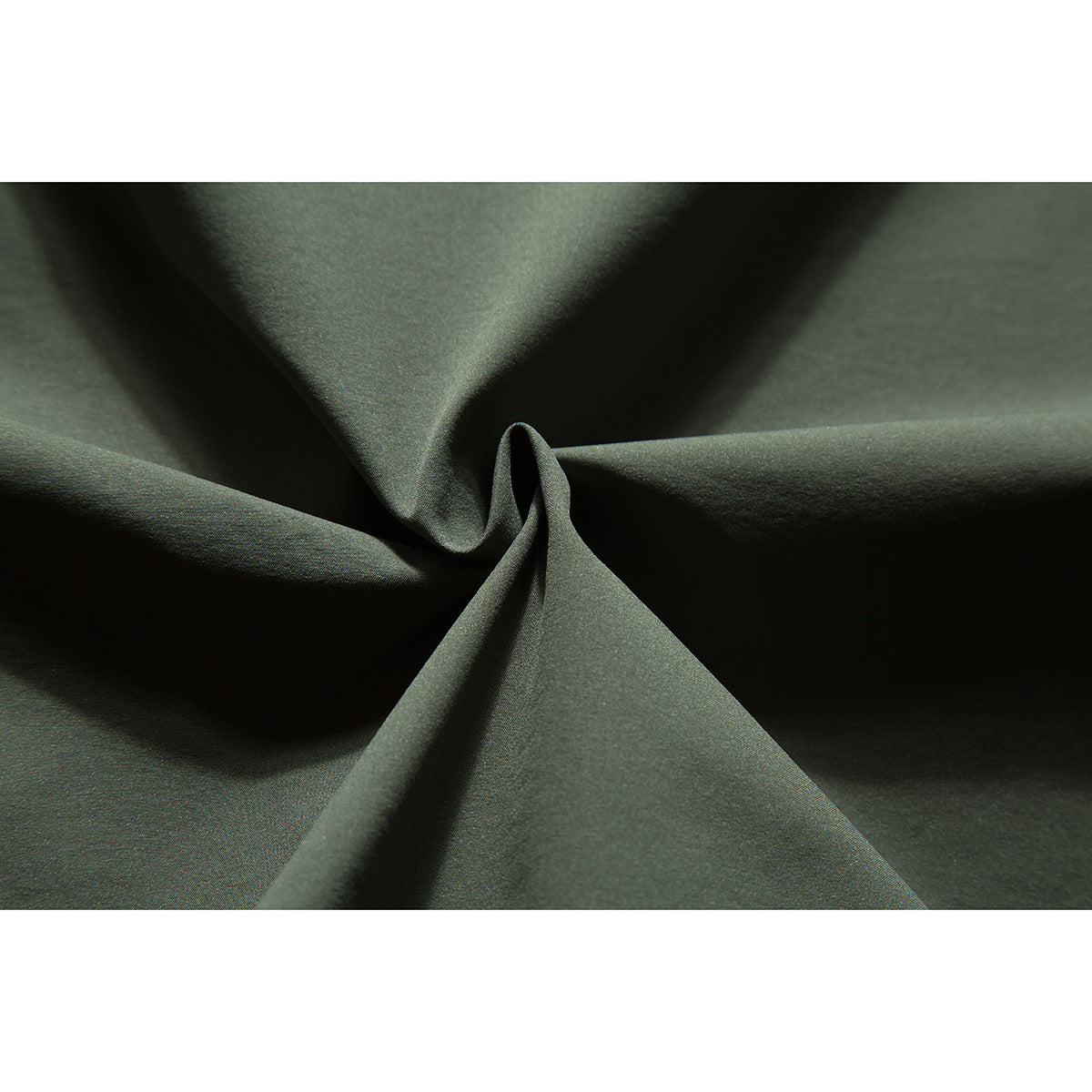 Close-up of olive-green fabric arranged in soft folds.