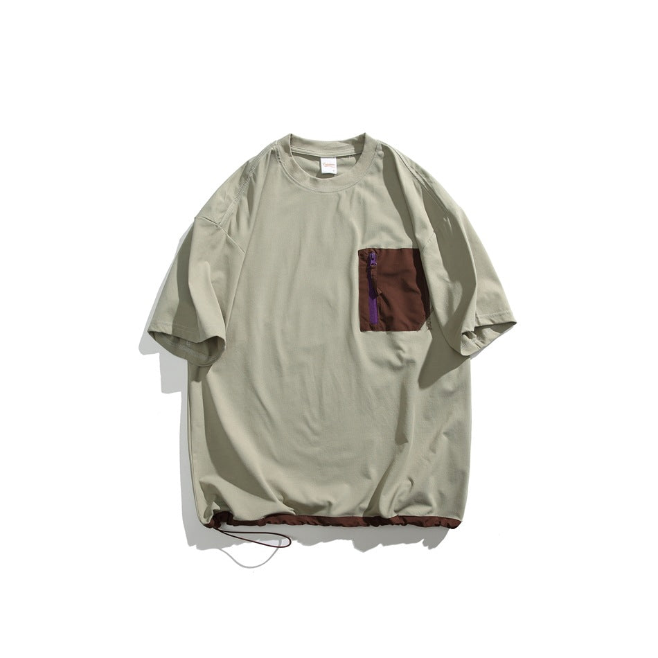 Light green short-sleeve crewneck T-shirt with brown zippered chest pocket and brown hem trim with drawcord, flat lay