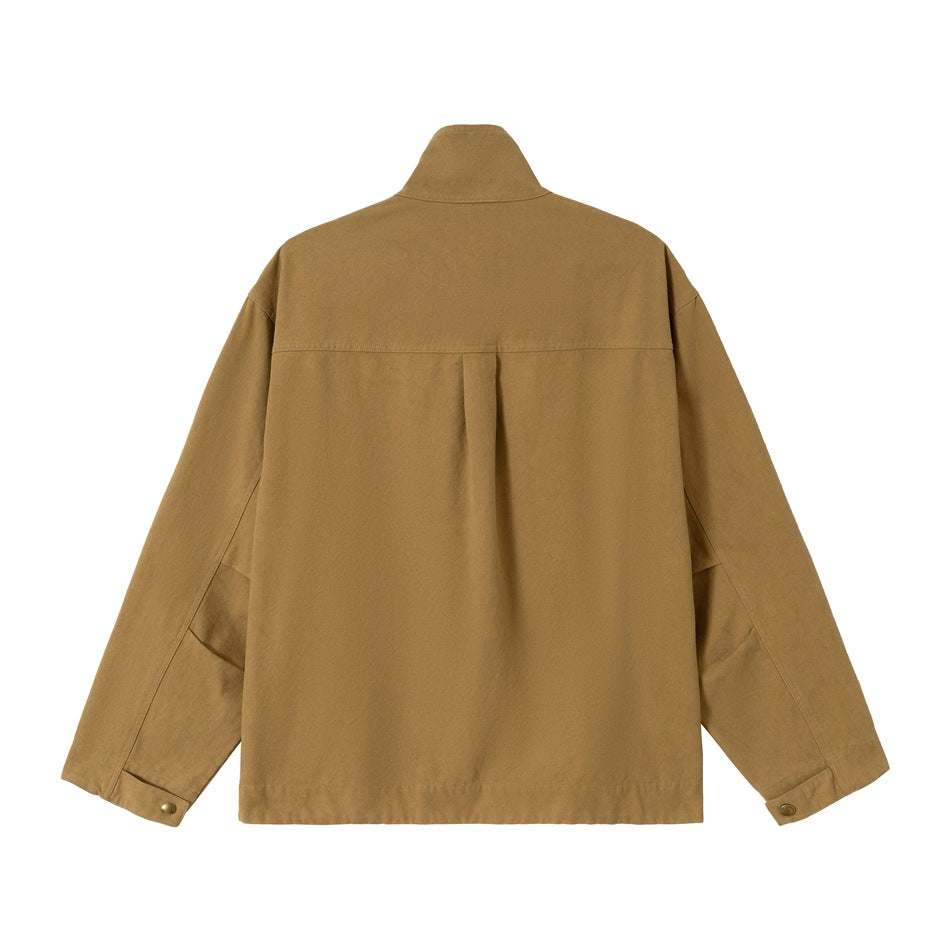 Back view of an ochre jacket with a raised collar, shoulder yoke, center pleat, and buttoned cuffs.