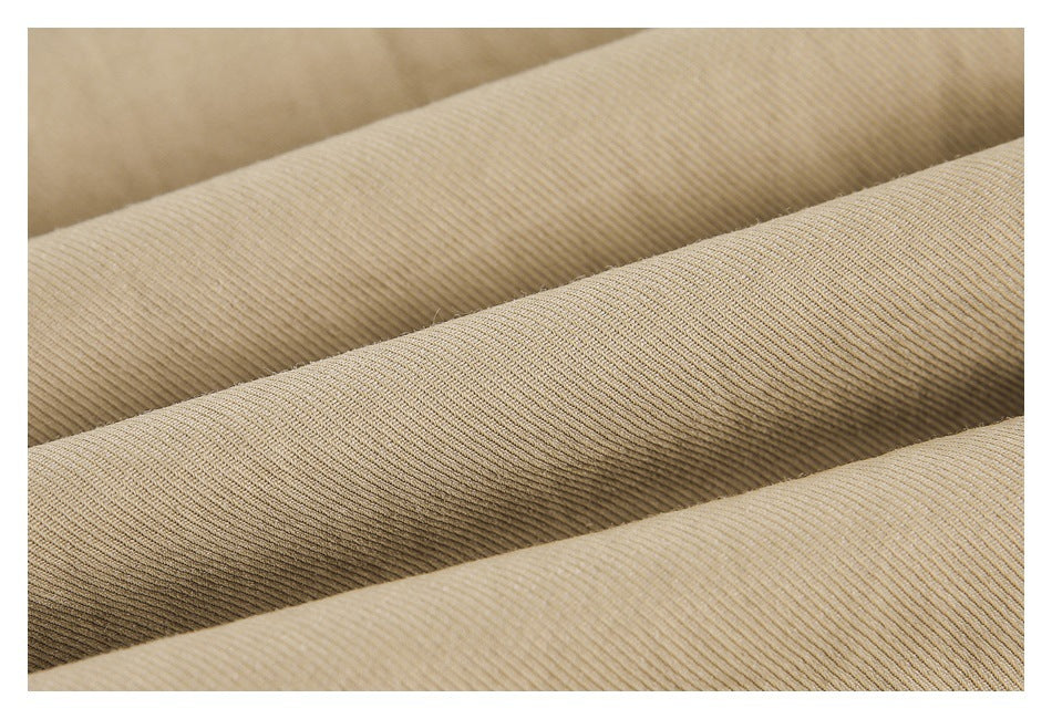 Extreme close-up of the fine ribbed texture of khaki-colored fabric.