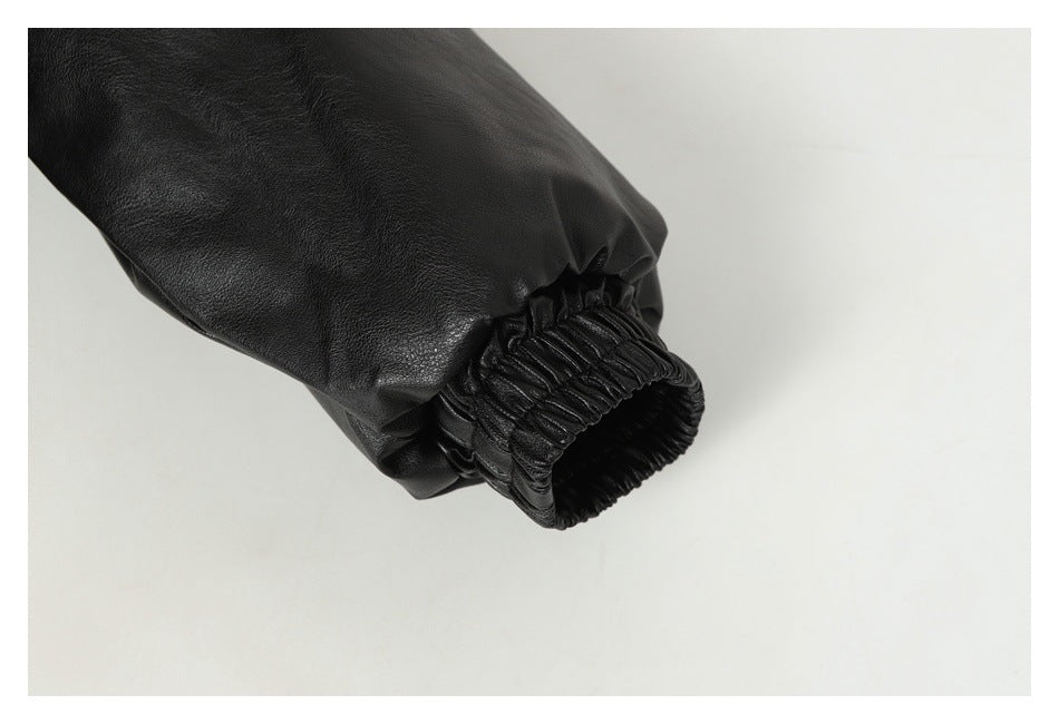 Close-up of a black jacket sleeve ending in a gathered elastic cuff.
