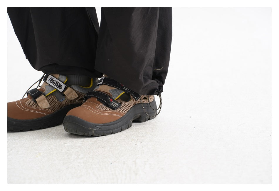 Close-up of black pant hems gathered over brown and black trail shoes.