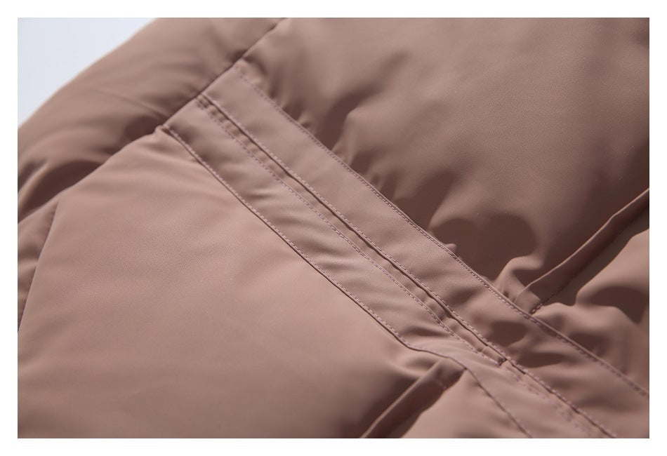 Close-up of the dusty mauve jacket's stitched seam and overlapping fabric panels.