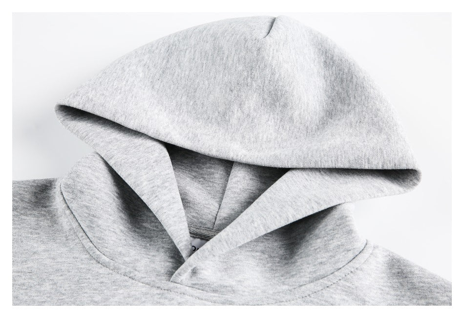 Close-up of a light gray hoodie hood, showing its opening, inner panels and neckline stitching.
