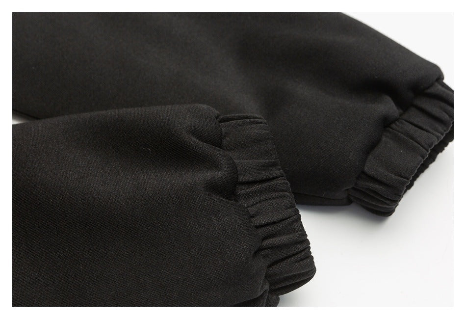 Close-up of black sleeves with gathered elastic cuffs.