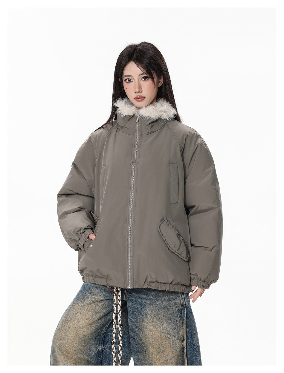 Three-quarter front view of a model wearing a taupe-gray jacket with a cream fur-trimmed collar.