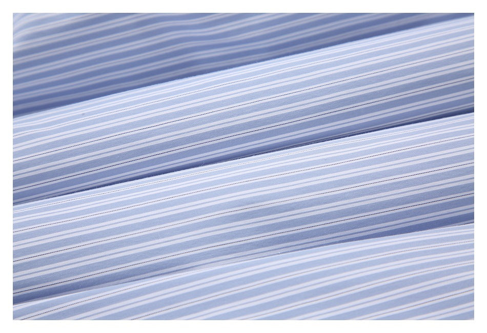 Close-up of layered, folded light blue and white striped fabric.