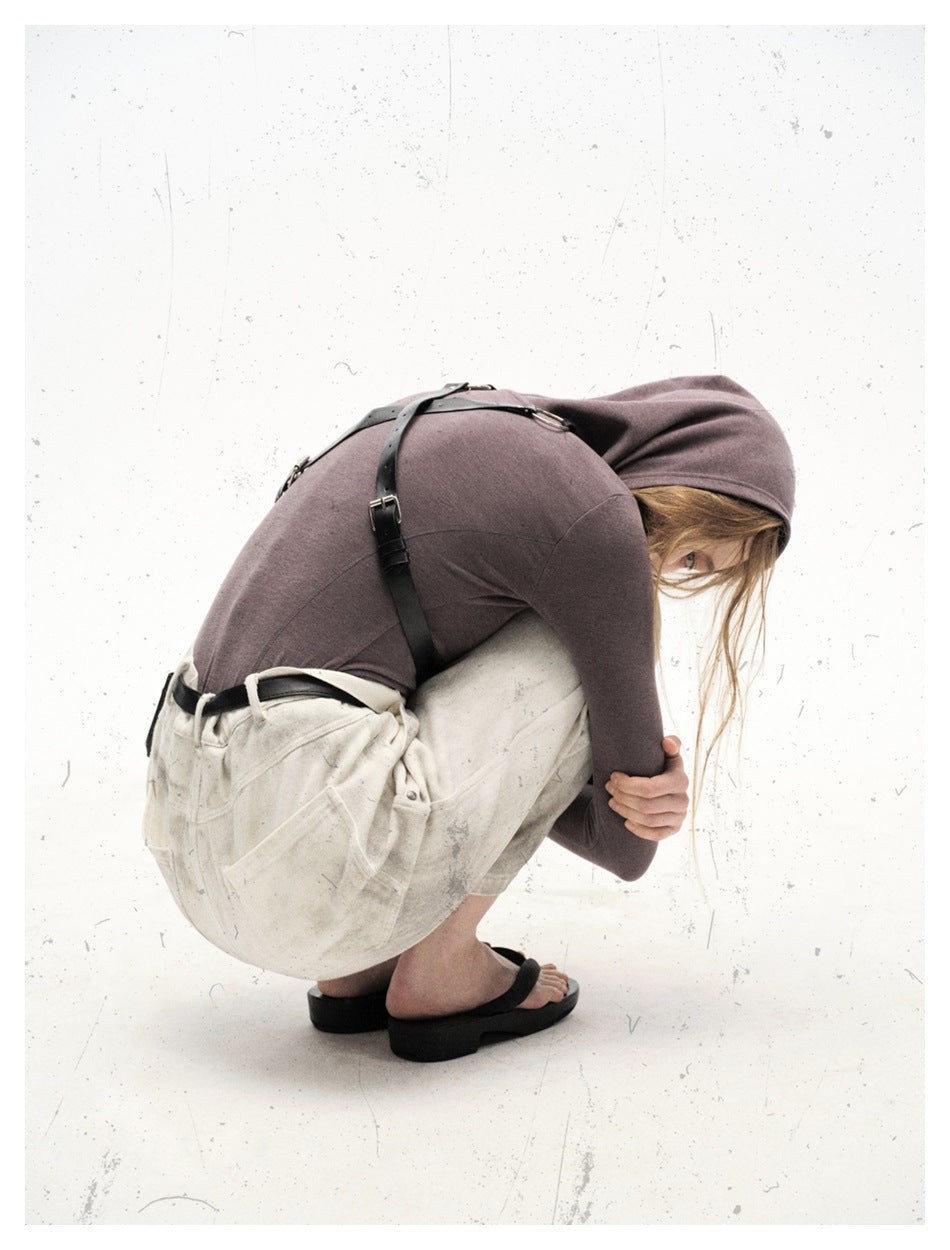 Model crouching in off-white, gray-marked wide-leg trousers, shown from the side and back.
