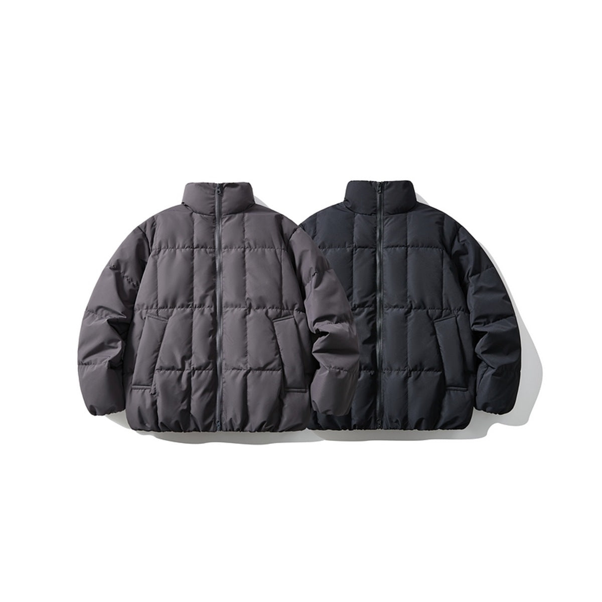 Front view of two puffer jackets with stand collars and front zippers, in charcoal gray and black.