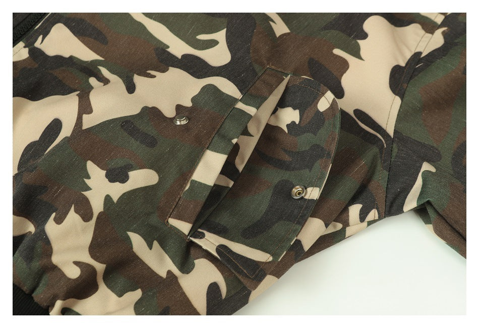 Close-up of a flap pocket with snap closures on the camouflage jacket.