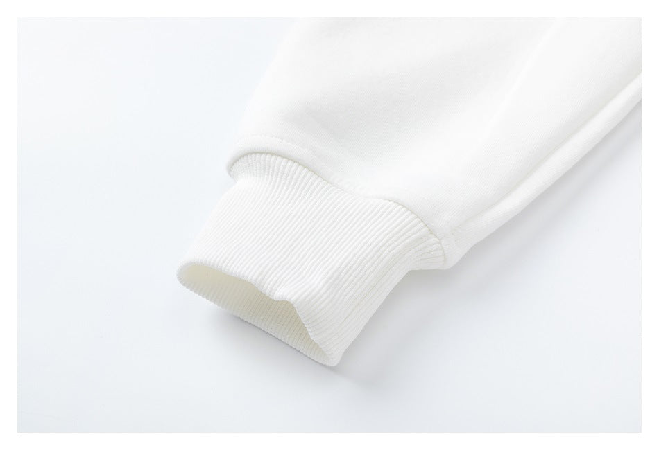 Close-up of a white sweatshirt sleeve ending in a wide ribbed cuff.