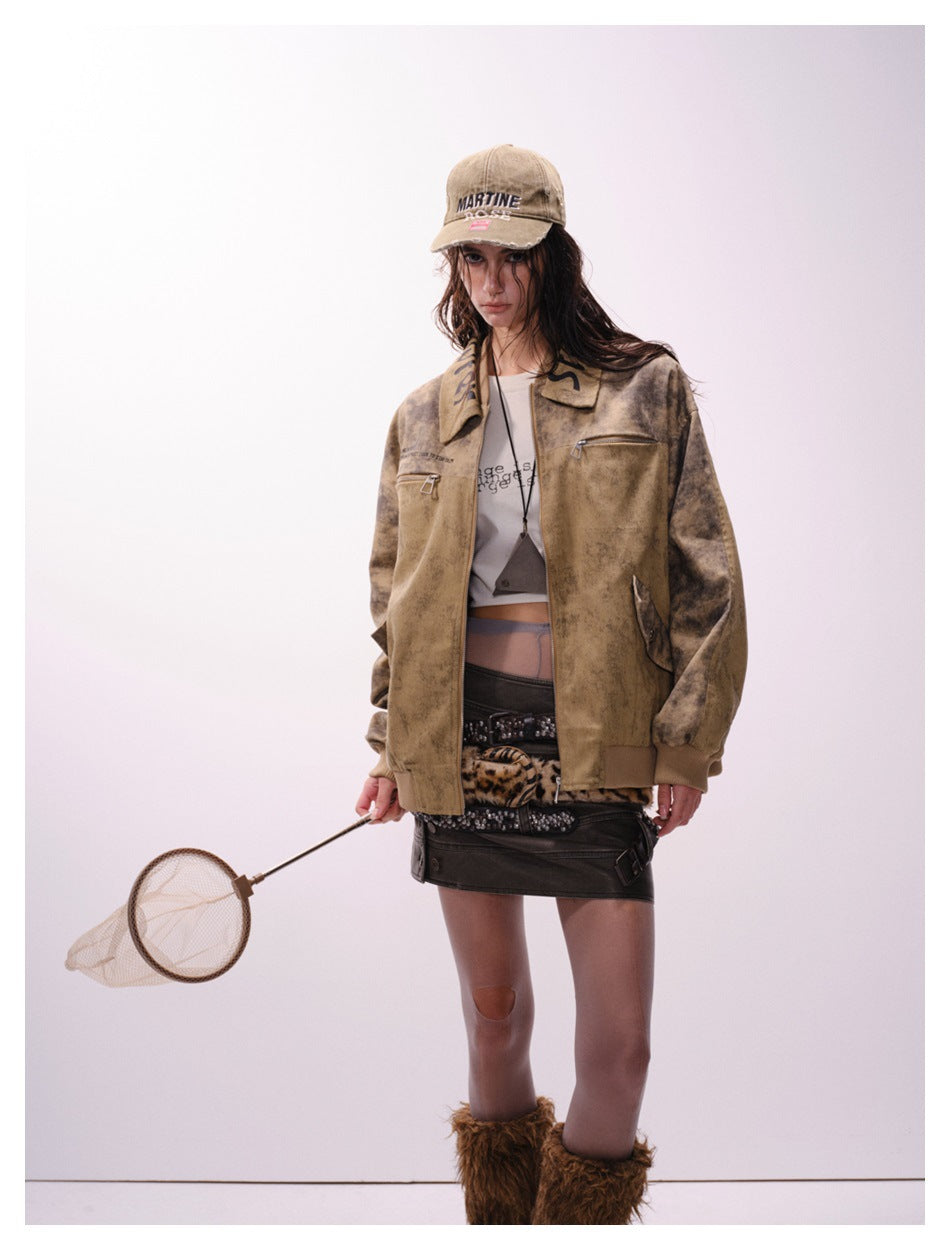 Model wearing an open mottled tan-brown jacket with darker sleeves, chest zip pockets and ribbed cuffs.