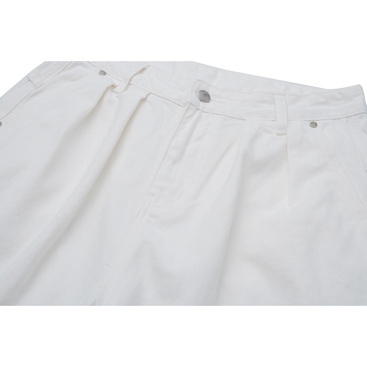 Close-up of white trousers showing the waistband, metal button, belt loops, and front pocket.