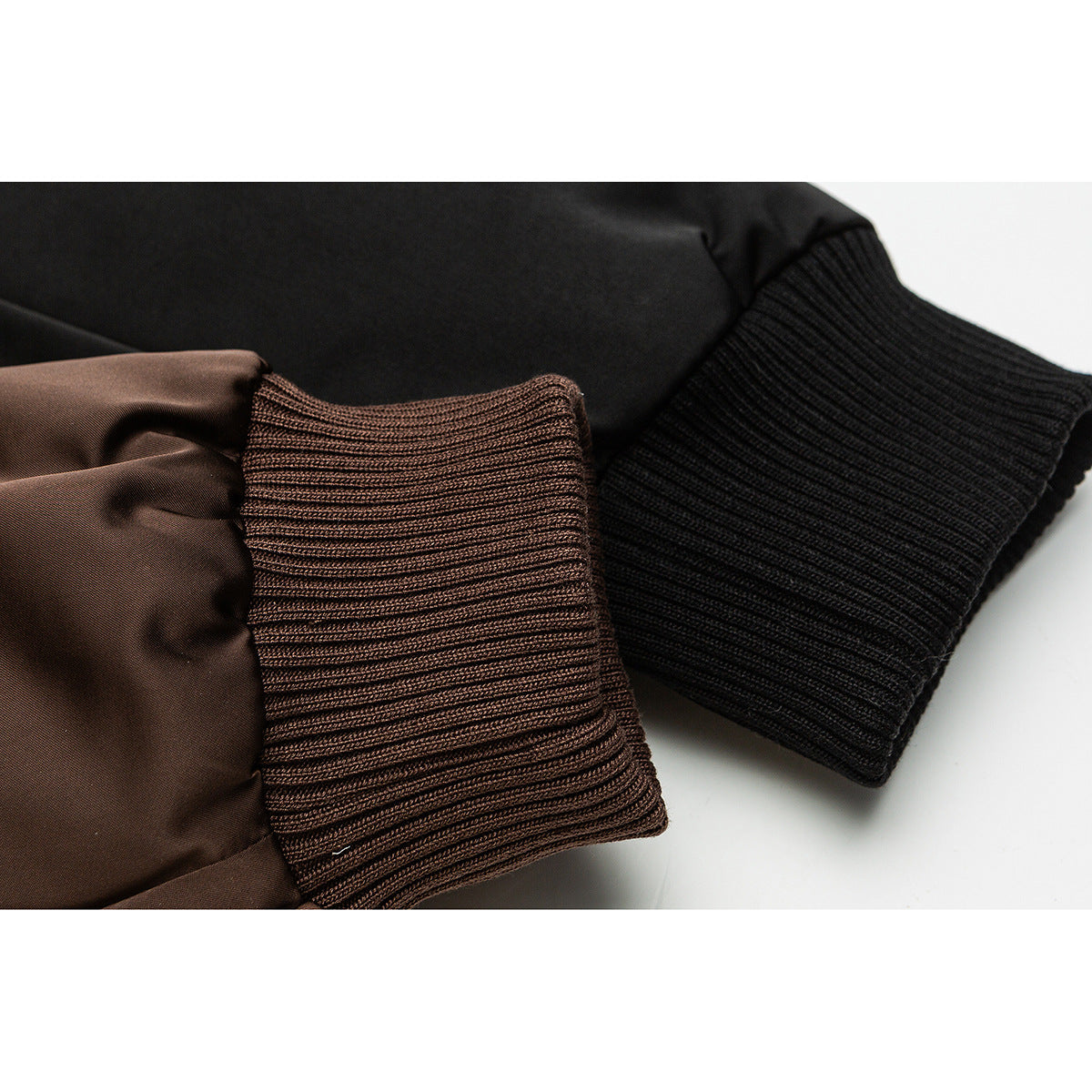 Close-up of brown and black rib-knit cuffs on a jacket.