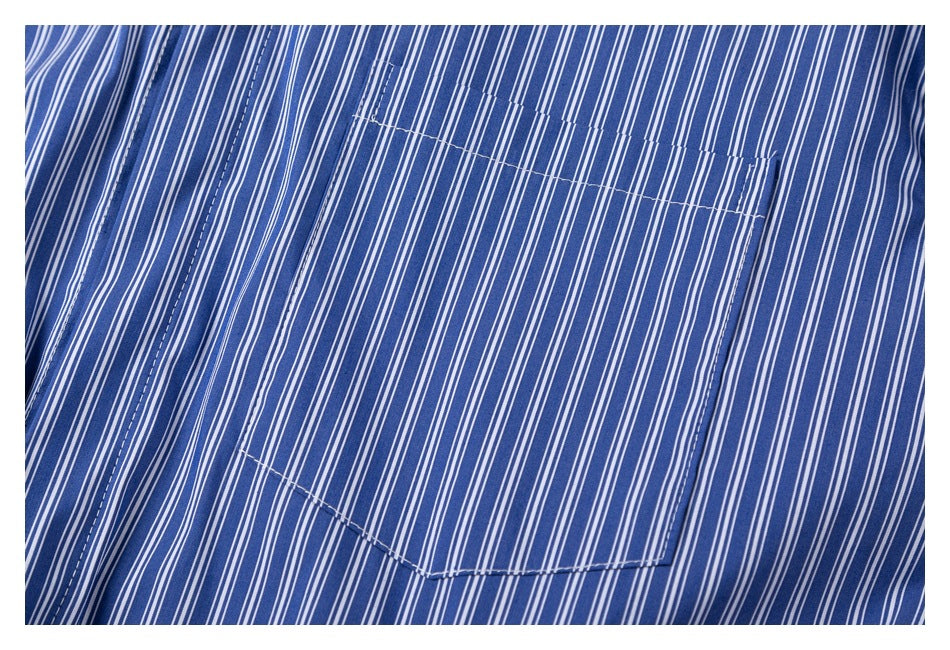 Close-up of the blue and white pinstriped shirt's single chest pocket and stitching.