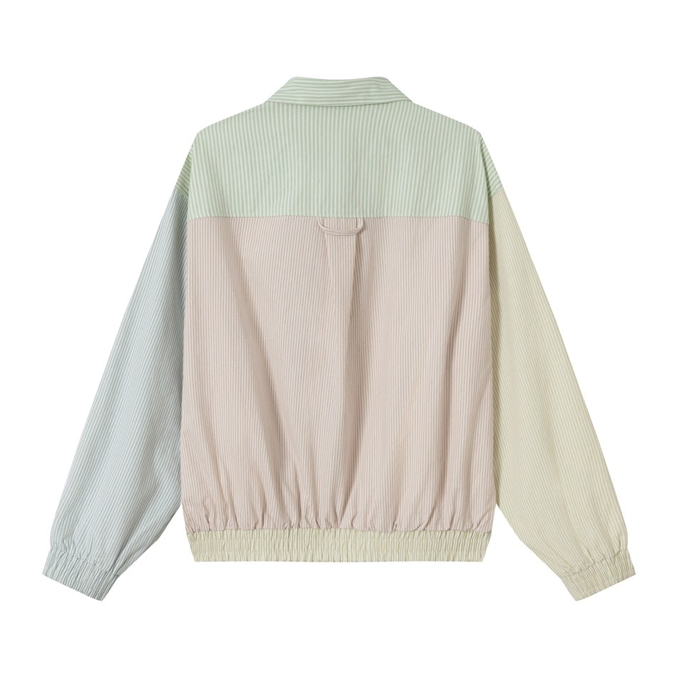 Back of a pastel color-block jacket with vertical pinstripes, gathered cuffs, and an elastic hem.