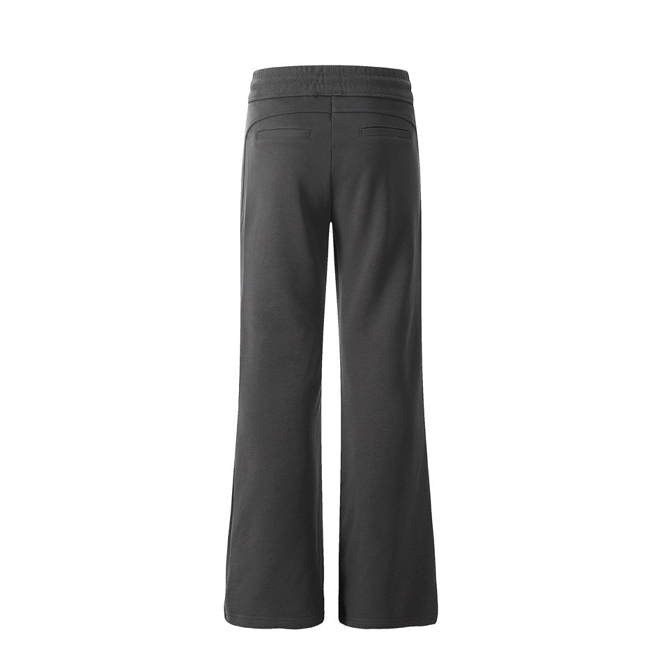 Back view of dark gray flared pants showing elastic waistband and two welt-style back pocket details